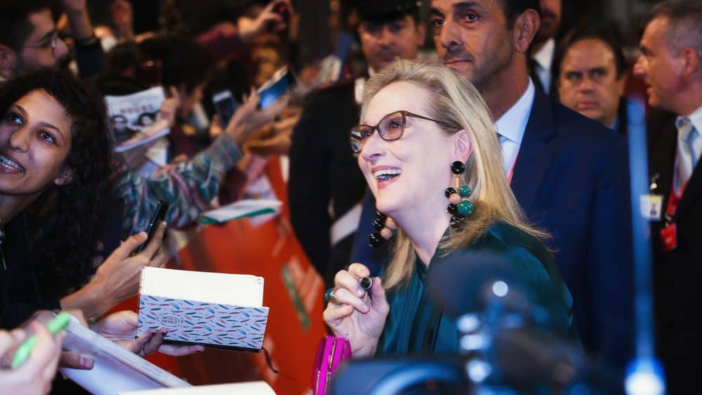 Meryl Streep signing autographs in a crowd