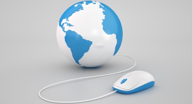 A computer mouse connected by a wire to a globe depicting some of the earth.