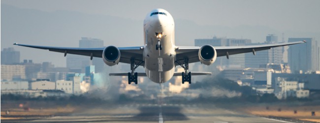 Photo of an airplane hovering over a runway, taking off.
