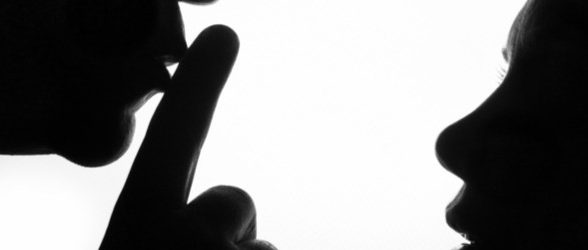 A silhouette of a person holding his fingers to his lips to shush a silhouette of a person looking up at them.