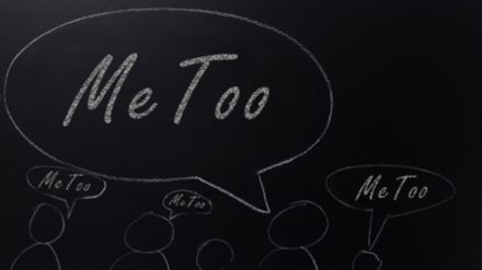 A blackboard with outlines of people all with speech bubbles that read "me too."