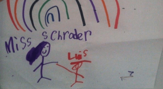 A child's drawing of a rainbow. Below the rainbow are two stick figures. One is Miss Scrader and one is Luis.