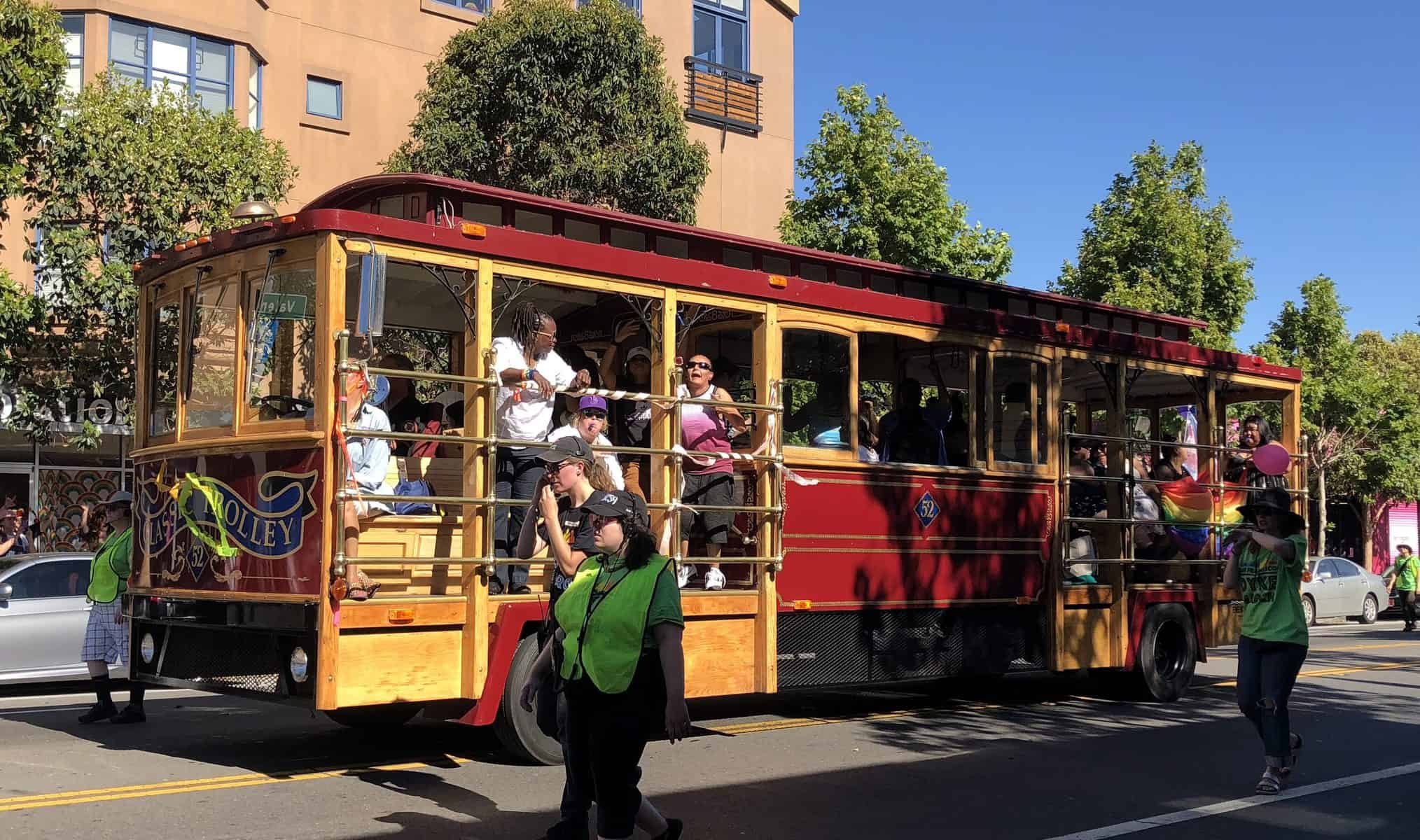 A trolley with people on it in rolling through a march.