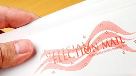 An envelope that says "Official Election Mail."