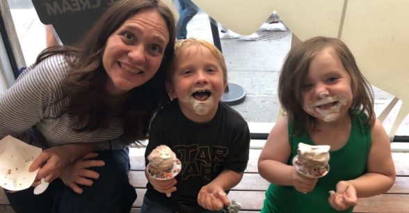 Photo of Heather and her two children, both with ice cream on their faces.