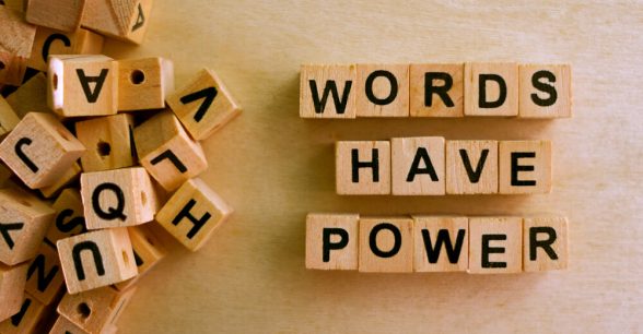 Letter tiles spelling out "words have power."