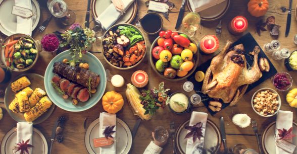 A wooden table filled with Thanksgiving food
