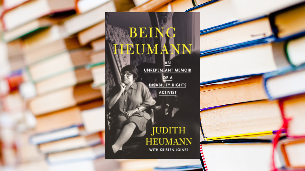 Photo of Judy Heumann's memoir cover superimposed over a background of stacks of books