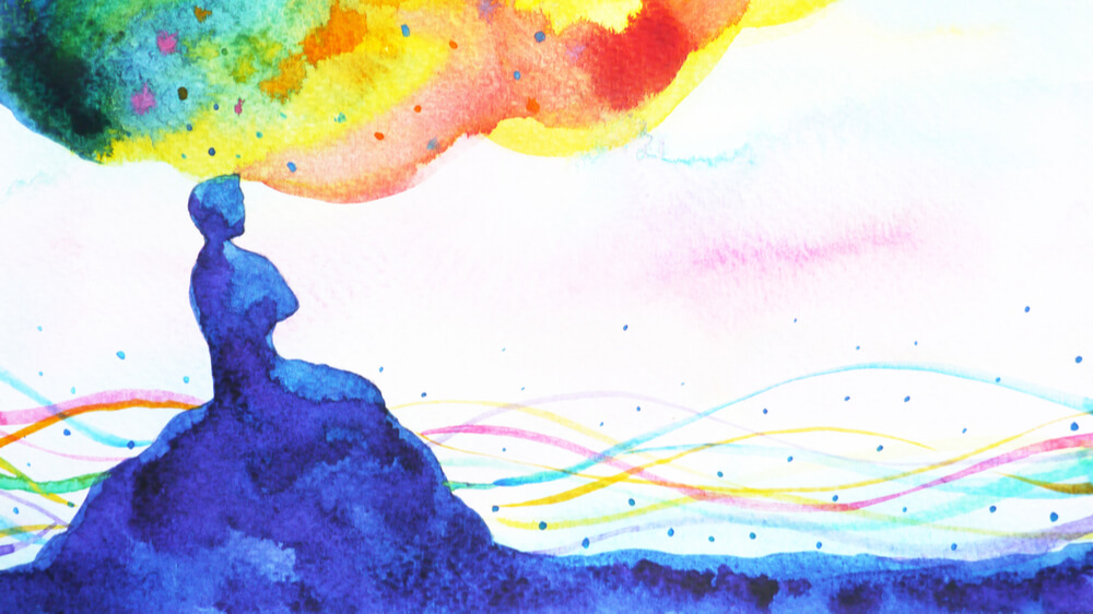 An abstract watercolor of a person sitting atop a hill with a rainbow cloud of thoughts emanating from their mind.