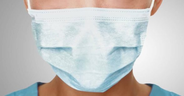 The lower half of a person's face, covered in a surgical mask.