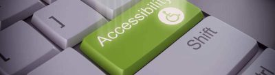 Computer keyboard with green key labeled "Accessiblity"