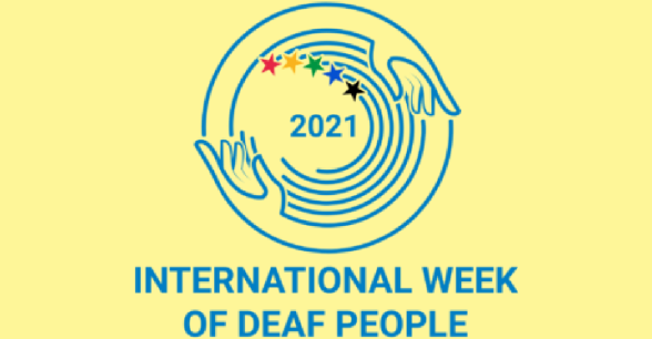 2021 International Week of Deaf People logo - a circle made of two hands surrounding a rainbow of stars