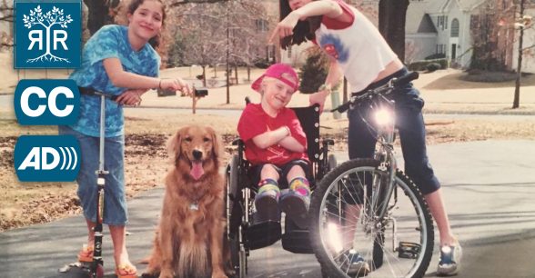 A young Daisy poses in their wheelchair with two friends and a panting golden retriever.