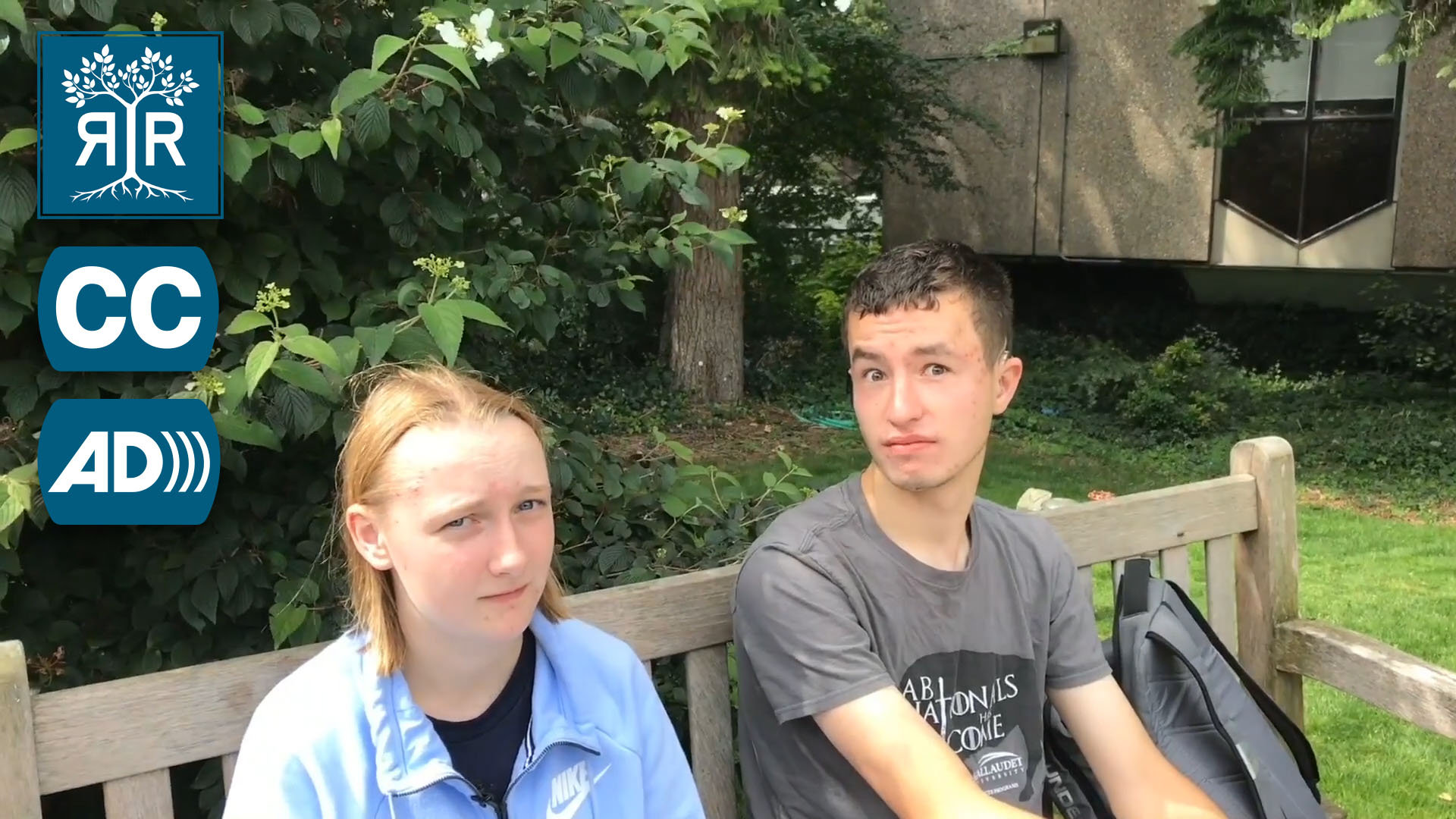 Two students on a bench grimace at the camera.