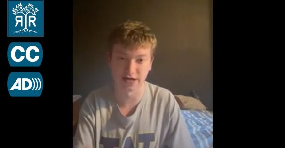 Miles speaks to camera from his bedroom. He is wearing a t-shirt with the University of Washington logo on it, which looks like a royal purple capital letter W with a gold border.