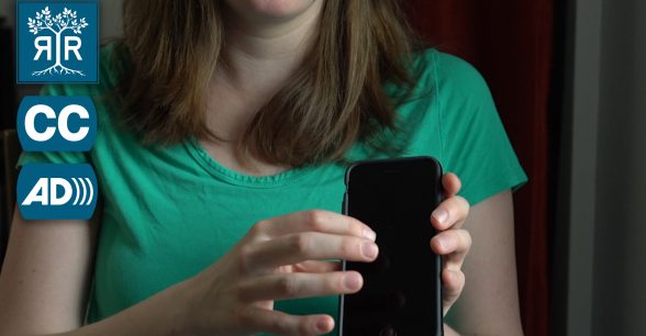Image of Cindy holding her phone to show how she listens to tweets being read to her.