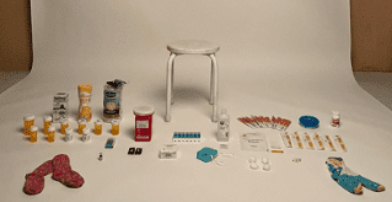 An assortment of medical instruments and personal effects, including pill bottles, needles, and socks, surround an empty white stool on a white background.